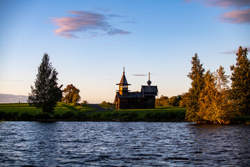 ancient churches on the island at sunset on the background of the lake
