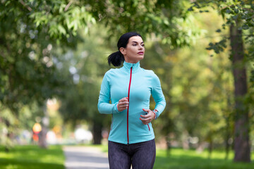 Female jogger is training in the park.