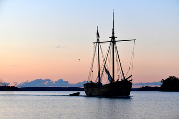 old northern boat on the lake at sunset