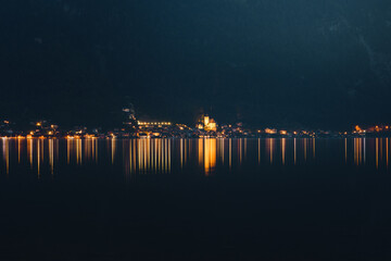 Lake panorama view with a old town illuminated lights and perfect reflections and mountain background. Hallstatt, Hallstätter See, Austrian Alps,Salzkammergut in Austria, Europe
