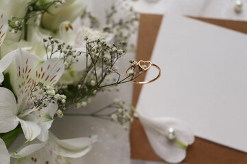 wedding card design. wedding rings on the table with flowers. marriage proposal