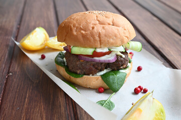 Milanese burger, with tomatoes, lettuce and french fries, in white background