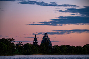 vintage churches on the island at sunrise on the background of the lake
