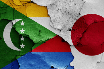 flags of Comoros and Japan painted on cracked wall