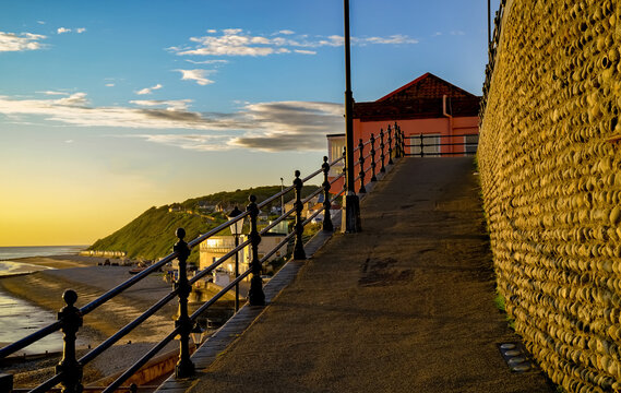A view up the ramp from the beach to the town centre in the seaside town of Cromer. Captured at sunrise on a bright summer morning.