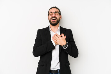 Young caucasian business man isolated on a white background laughing keeping hands on heart, concept of happiness.