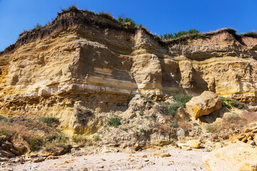 Fototapeta premium Landslide slope of mountain. Danger of rockfall, descent of stone avalanches. Mountain landscape of dangerous stony surfaces.