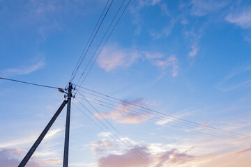  pole with electric wires against the sky