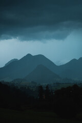 Heavy summer thunderstorm weather with moody dark vibes in the mountains with panorama landscape view and mountain silhouettes of the heavy rain. Austrian Alps, Salzkammergut in Austria, Europe