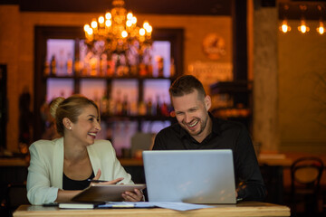 Young business couple working on tablet and computer
