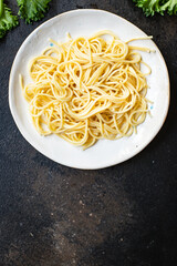 spaghetti pasta on a plate macaroni from semola durum wheat on the table serving portion size top view place copy space for text