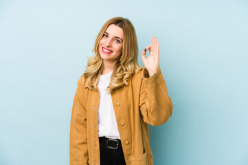 Young blonde pretty woman isolated cheerful and confident showing ok gesture.