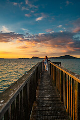 Fototapeta na wymiar woman on a pier at sunset
