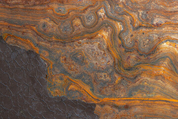 metal surface with curly rust, remnants of the old paint coating