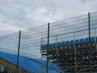Tennis grandstand detail with blue seats no viewers in Budapest suburb, Hungary