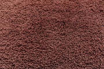 The texture of a brown carpet. Fleecy surface. Background