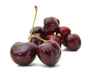 Handful of a red cherry on a white background