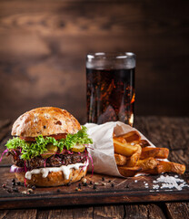 Close-up of home made tasty burger on wooden table.