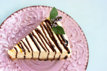 A piece of cheesecake on a pink plate, a delicious and healthy dessert. © vita