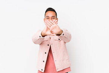 Young latin man posing isolated doing a denial gesture