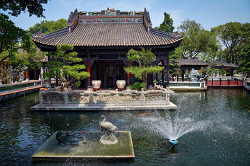 a fountain in the park with feng Shui symbols. A snake lying on a turtle and a crane. They symbolize happiness , good luck and protection from all sorts of misfortunes. Baomo park, Guangzhou China