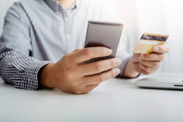businesswoman hand using smart phone,mobile p payments online shopping,omni channel,digital tablet docking keyboard computer at office in sun light