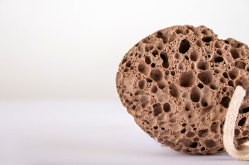 Pumice stone close up and copy space. Pumice stone isolated on white background. Beauty concept. Background for cosmetic product branding, identity and packaging inspiration.