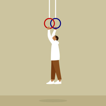 Man hanging holding hands on gymnastic rings