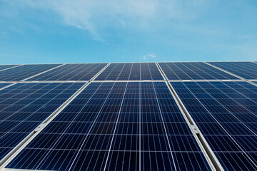 Obraz premium Photovoltaic power plant. Solar photovoltaic panels on blue sky background