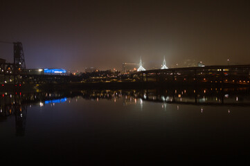 Fototapeta premium Highway Bridge and Buildings Reflected in Willamette River at Night, Portland, Oregon, USA