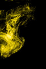 Obraz premium Yellow smoke on black background