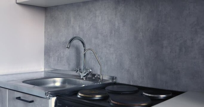 kitchen area, sink and stove in gray
