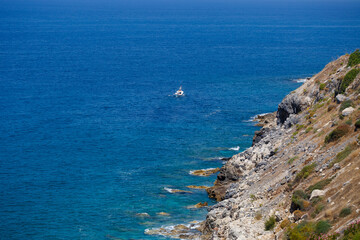 A view of the Mediterranean coast with waves of azure water. Summer seascape. Seaside in sunny weather. Beautiful sea view