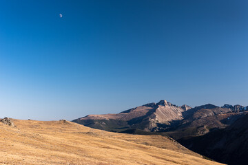 Trail Ridge view point of Longs Peak with moon in the late afternoon light. 14,259 foot Longs Peak is the highest point in Rocky Mountain National Park in Colorado. 