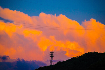 Clouds approach the power transmission tower