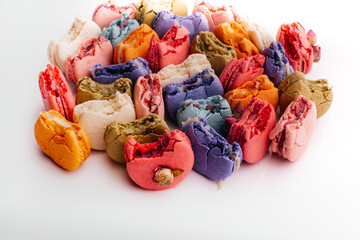 Multicolored macaroon and bitten halves	