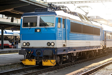 Fototapeta premium Passenger Train Waiting on the Platform of the Main Station, Electric Locomotive on an European Railway, Efficient Travel by Rail