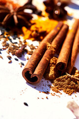 Close-up spices paprika, turmeric, star anise, sesame, red, black, white pepper, garlic, cinnamon sticks, cloves, cumin, chili, Bay leaves on white background with copy space. food kitchen herbs.