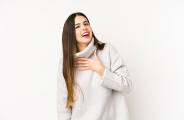 Naklejka premium Young caucasian woman isolated on a white background laughs out loudly keeping hand on chest.