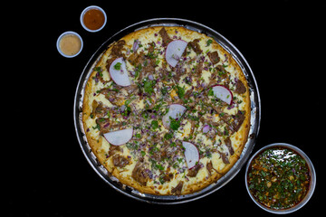 Artisan pizza served with birra sauce. street food