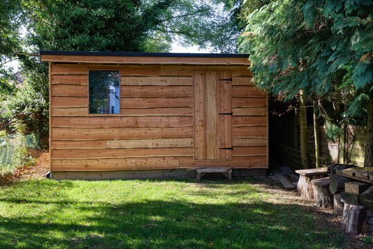 Waney edge wooden rustic garden shed.
