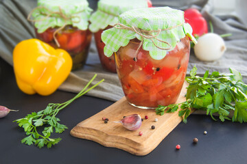 Jars of tasty pickled vegetables on a table. Creative atmospheric decoration.