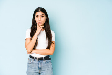 Young indian woman on blue background having some great idea, concept of creativity.