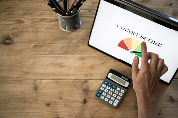 online finances hand pressing credit score button on tablet
