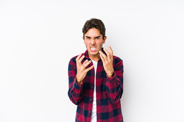 Young caucasian man posing in a pink background isolated upset screaming with tense hands.