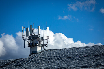 4G, 5G telecommunications transmitters on a roof of a building. Cellular base station with...