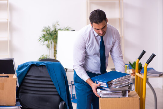 Young male employee in moving concept