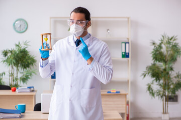 Fototapeta premium Young male doctor virologist in the office