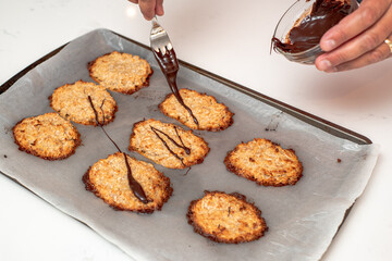 Coconut and banana cookies preparation drizzled with melted chocolate. Baking