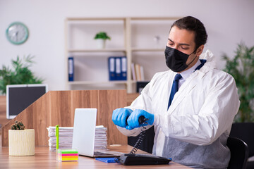 Young male employee in self-isolation concept